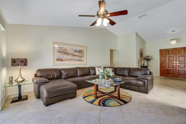 living room featuring light tile patterned floors, a textured ceiling, vaulted ceiling, and ceiling fan