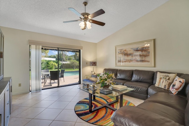 living room featuring vaulted ceiling, light tile patterned floors, a textured ceiling, and ceiling fan