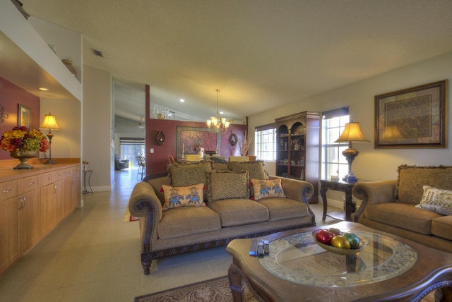 living room featuring lofted ceiling and an inviting chandelier