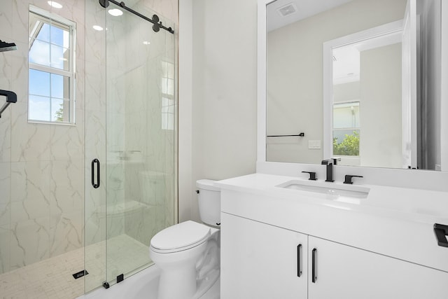 bathroom with toilet, vanity, a marble finish shower, and visible vents