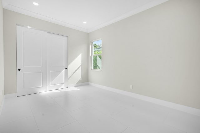 unfurnished bedroom with ornamental molding, recessed lighting, tile patterned flooring, and baseboards