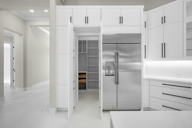 kitchen featuring light tile patterned floors, recessed lighting, stainless steel built in fridge, and white cabinetry