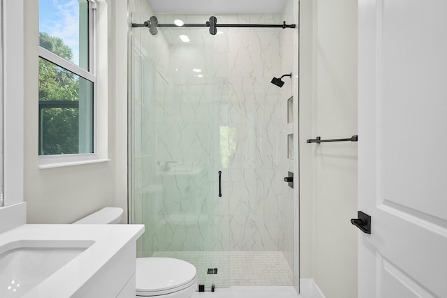 full bathroom featuring toilet, a marble finish shower, and vanity