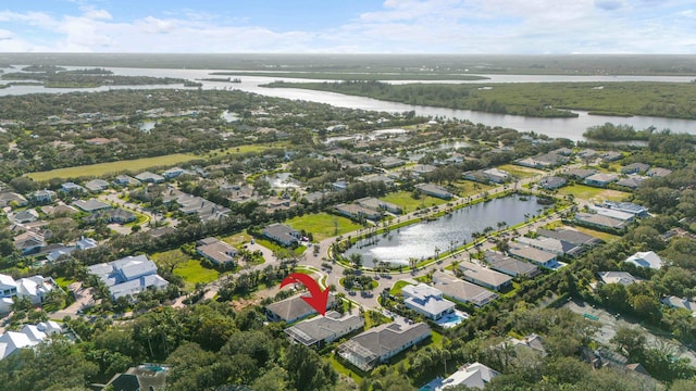 drone / aerial view with a water view and a residential view