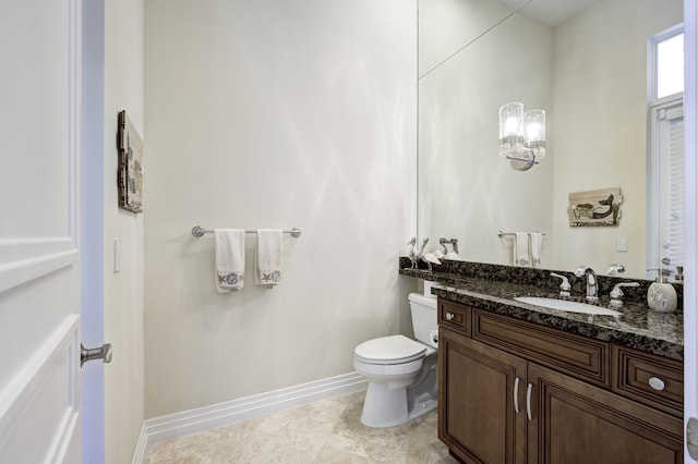 bathroom featuring tile patterned flooring, vanity, and toilet