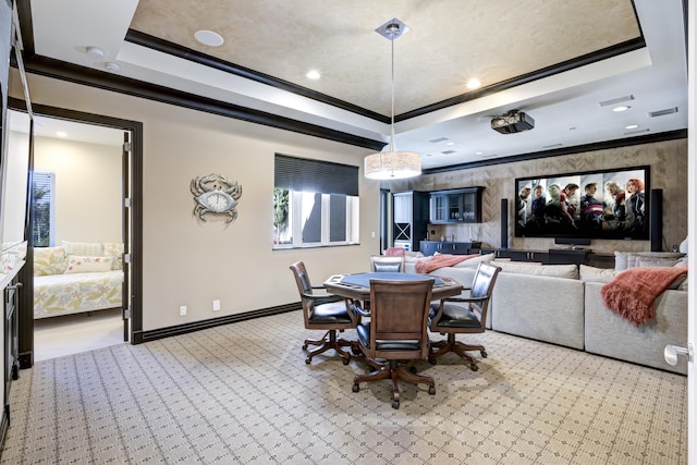 dining space featuring a tray ceiling and ornamental molding