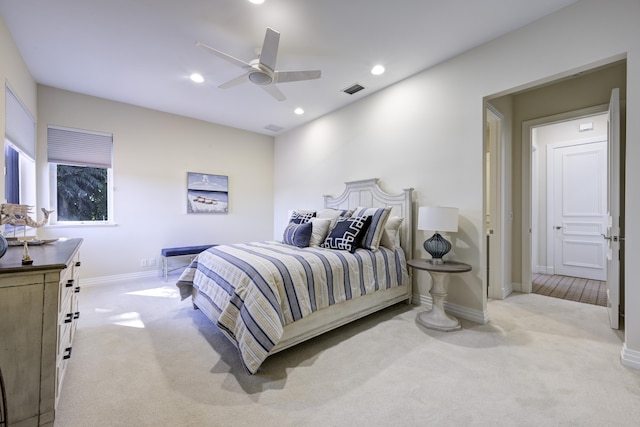 bedroom featuring ceiling fan and light carpet