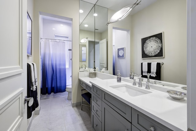 bathroom featuring vanity, a shower with shower curtain, and toilet