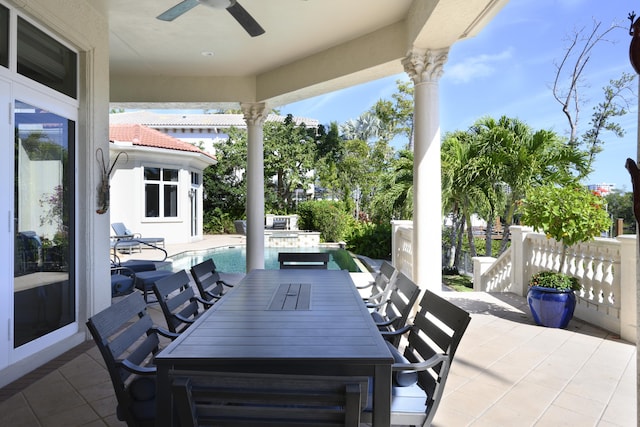 view of patio featuring a fenced in pool and ceiling fan