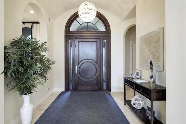 entryway featuring lofted ceiling and a notable chandelier