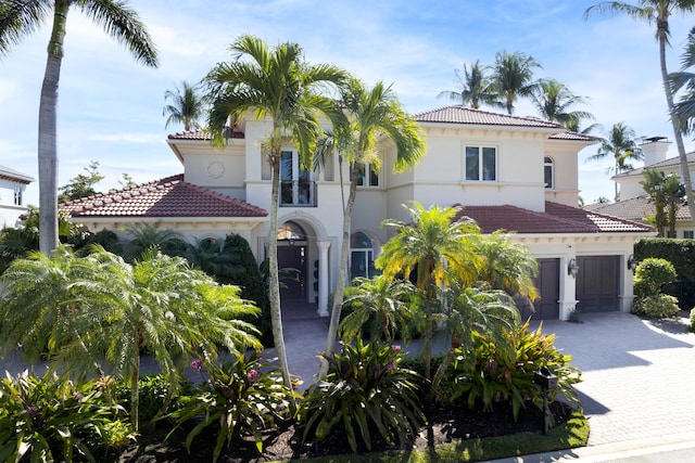 mediterranean / spanish house featuring a garage