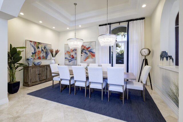 dining room with ornamental molding, a chandelier, and a tray ceiling