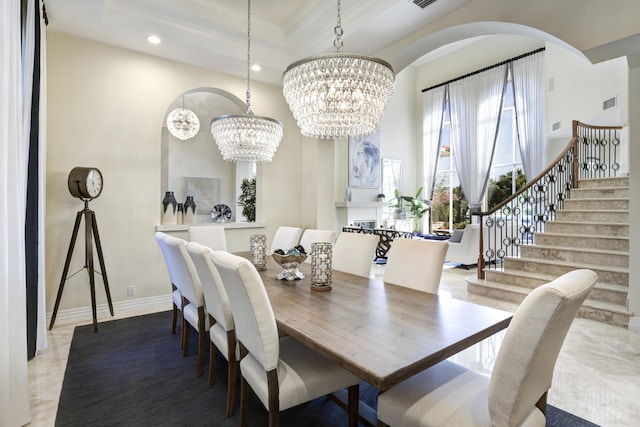 dining room with an inviting chandelier and a tray ceiling