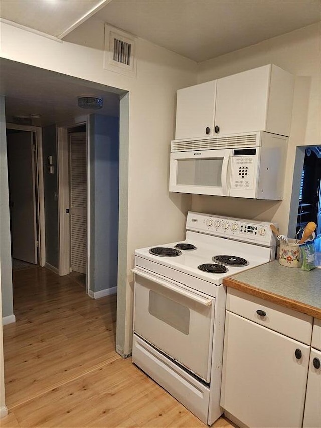 kitchen featuring white cabinetry, white appliances, and light hardwood / wood-style floors