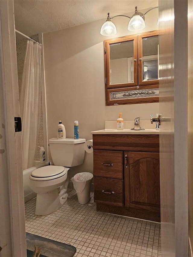 full bathroom with vanity, shower / tub combo with curtain, a textured ceiling, and toilet