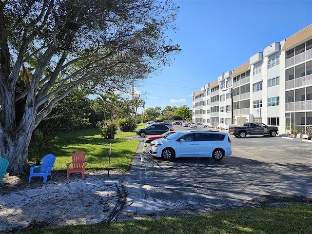 view of vehicle parking featuring a lawn