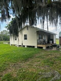 back of property featuring a yard