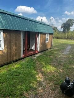 view of outbuilding featuring a yard