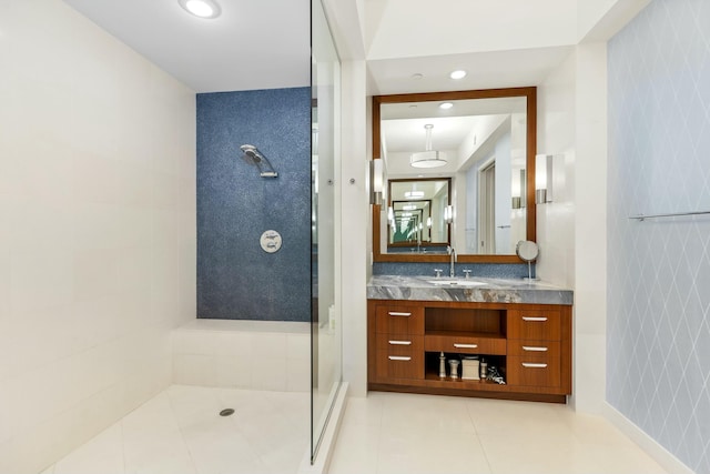 full bathroom with tile patterned flooring, a tile shower, vanity, and recessed lighting