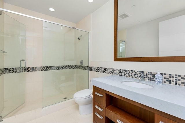 full bath with vanity, a stall shower, backsplash, and toilet