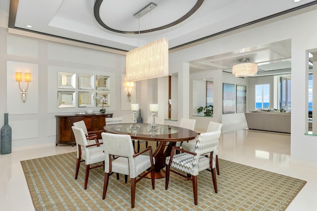 dining area with a chandelier, tile patterned flooring, and a raised ceiling