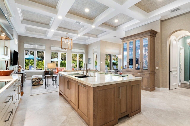 11205 Orange Hibiscus Ln, Palm Beach Gardens, FL 33418 - kitchen featuring a sink, coffered ceiling, arched walkways, beamed ceiling, and a center island with sink