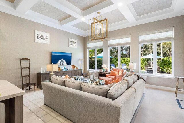 living room with beamed ceiling, ornamental molding, coffered ceiling, and an inviting chandelier