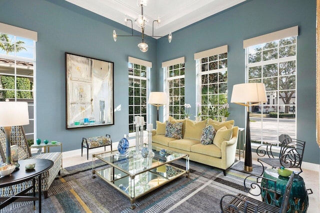 interior space with ornamental molding, plenty of natural light, and a notable chandelier