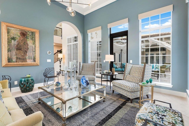 living room with a high ceiling and ornamental molding