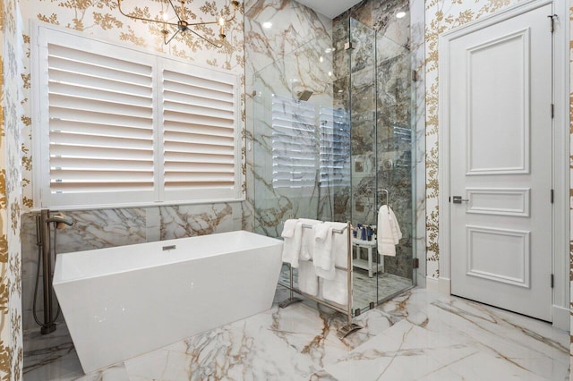 bathroom with independent shower and bath and an inviting chandelier