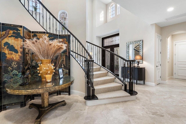 stairway featuring a high ceiling