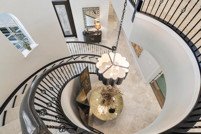 stairway with an inviting chandelier