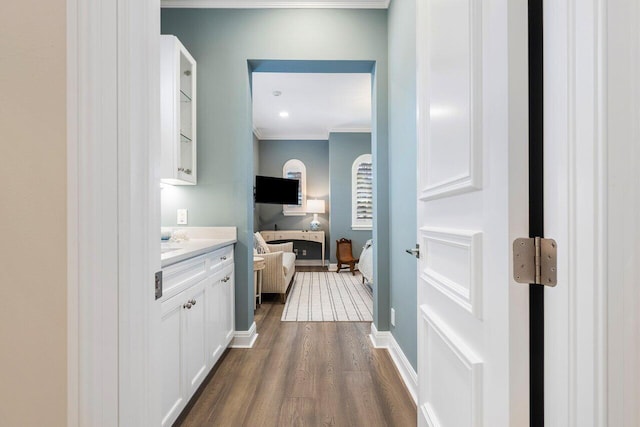 hallway featuring ornamental molding and dark wood-type flooring