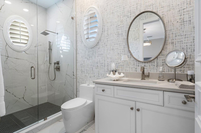 bathroom featuring vanity, a shower with door, and toilet