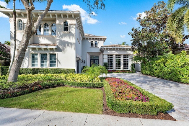 mediterranean / spanish house with a front yard