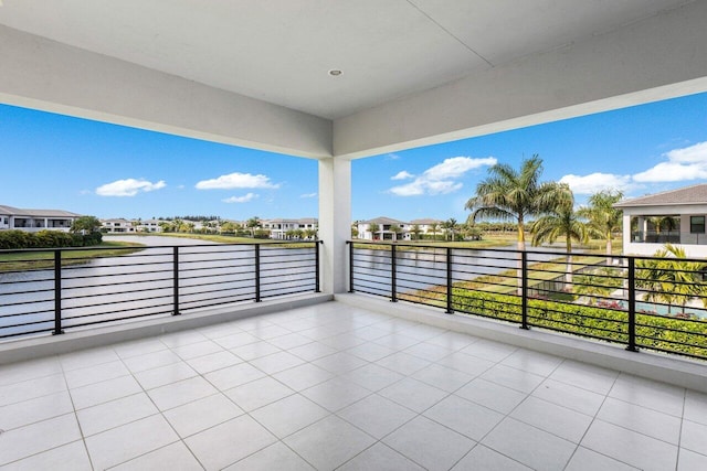 view of patio featuring a balcony and a water view