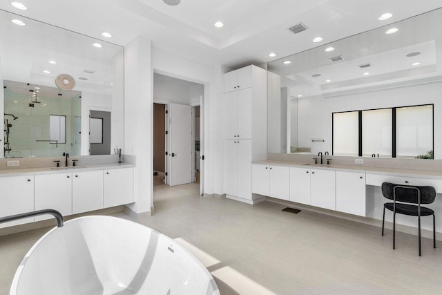 bathroom with independent shower and bath, vanity, and a tray ceiling