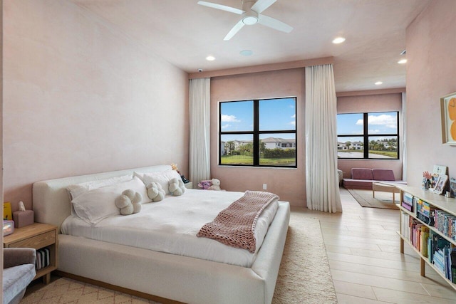 bedroom with ceiling fan and light wood-type flooring