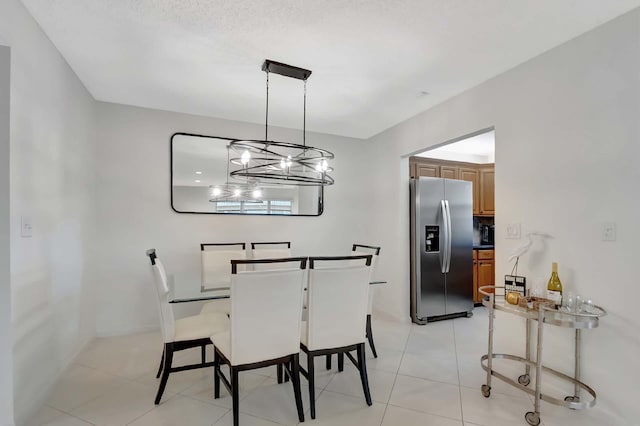 tiled dining room with a notable chandelier