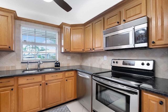 kitchen with sink, backsplash, stainless steel appliances, and light tile patterned flooring