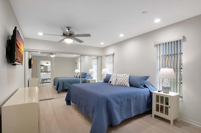 bedroom with ceiling fan, a closet, and light wood-type flooring