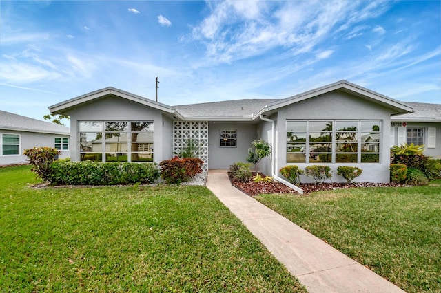 ranch-style home with a front lawn