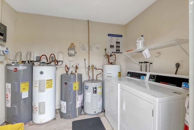 clothes washing area featuring separate washer and dryer and water heater