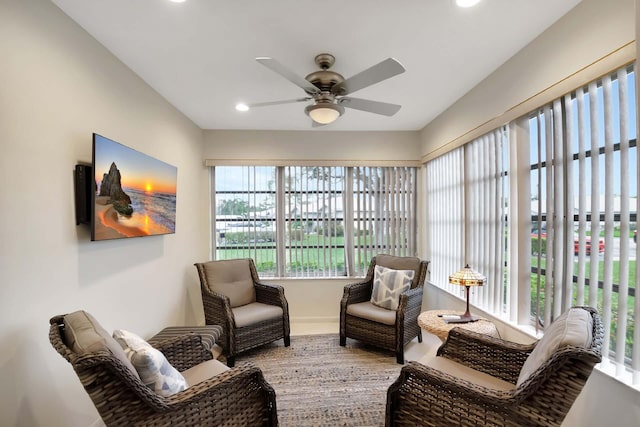 sunroom / solarium featuring ceiling fan