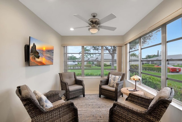 sunroom / solarium featuring ceiling fan