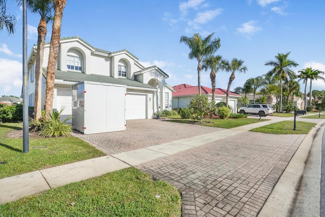 4209 Bahia Isle Cir, Wellington, FL 33449 - view of front facade featuring an attached garage, a front lawn, stucco siding, decorative driveway, and a tiled roof