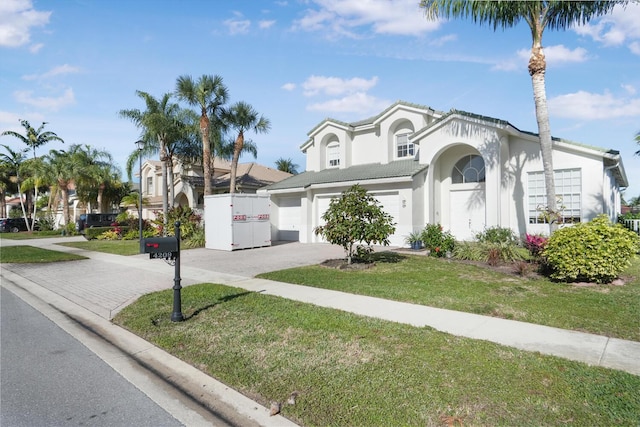 view of front of property with a garage and a front yard