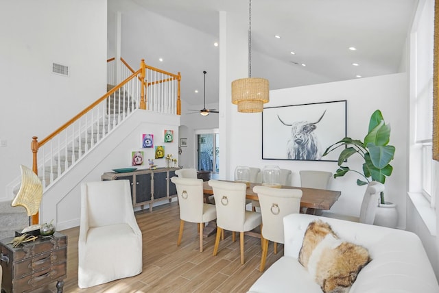 interior space featuring light hardwood / wood-style flooring and a high ceiling