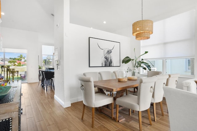 dining area with a high ceiling and a notable chandelier