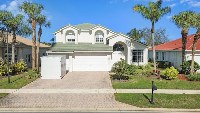 4209 Bahia Isle Cir, Wellington, FL 33449 - view of front of home featuring an attached garage, a front lawn, a tile roof, stucco siding, and decorative driveway